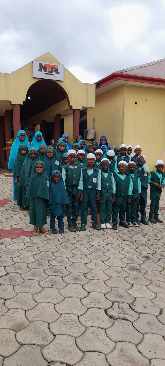 IQRA Model School pupils together in their green uniforms during a school outing